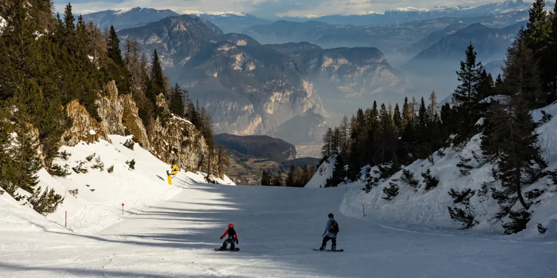 Family skiing in Andalo, one of the best ski resorts in Italy for families.