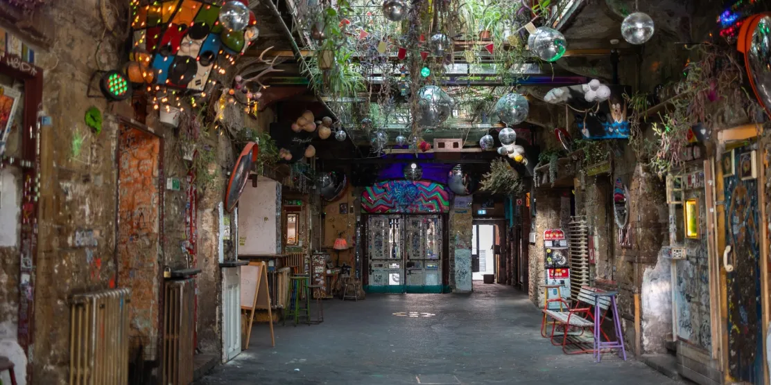 Interior of a colourful ruin pub in Budapest, Hungary, with eclectic decorations and disco balls