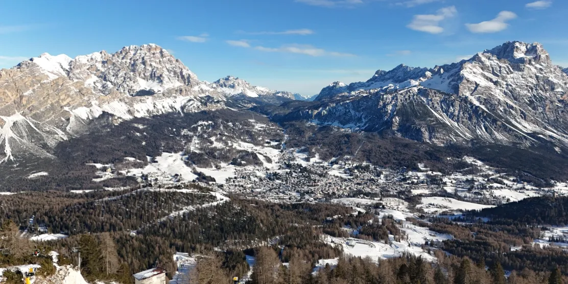 Cortina d'Ampezzo ski resort surrounded by the snow-covered Dolomites in Italy.