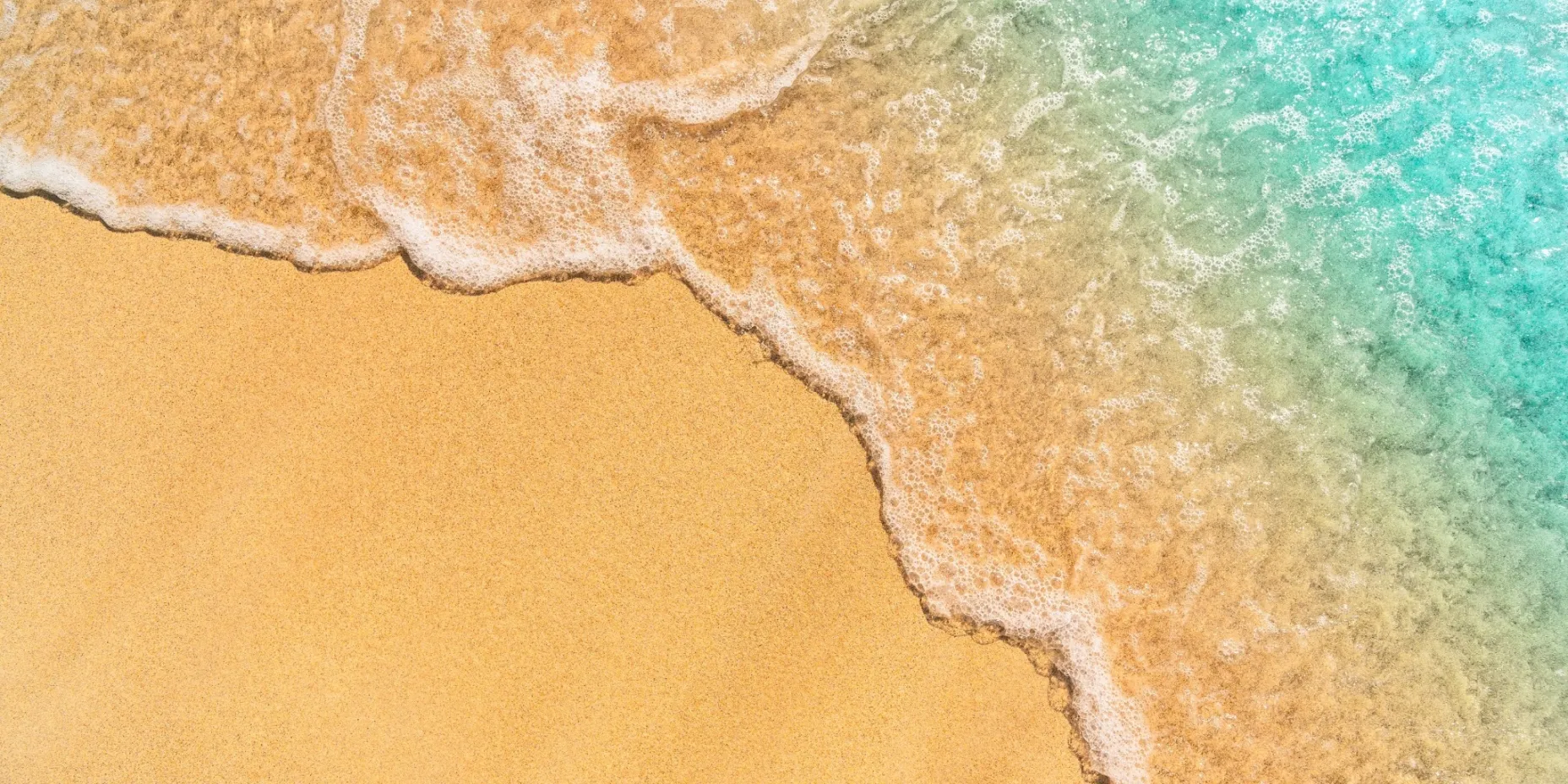 Golden sandy beach and turquoise sea at a warm destination in December