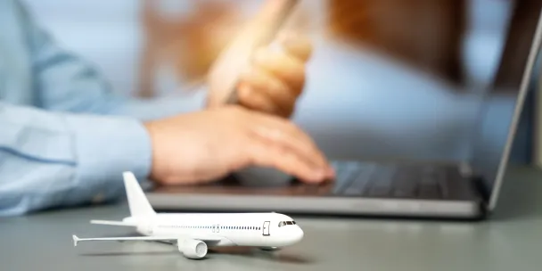 Plane figurine next to laptop